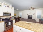 The fully equipped kitchen has stainless steel appliances and granite countertops